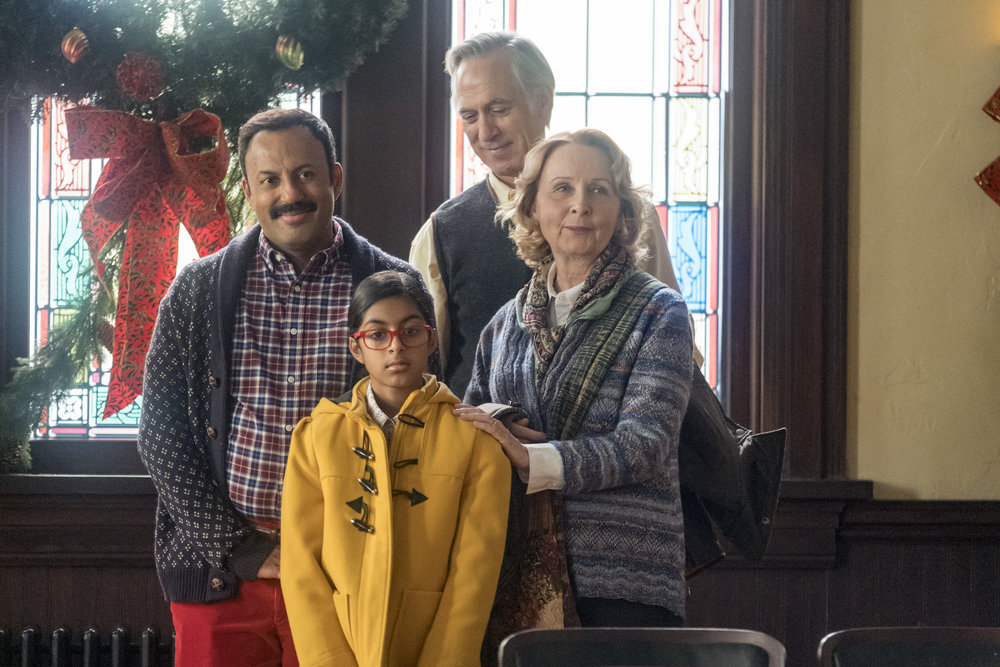 PERFECT HARMONY -- "Merry Jaxmas" Episode 110 -- Pictured: (l-r) Rizwan Manji as Reverend Jax, Ayana Manji as Anjali, Tom Amandes as Luke, Kate Burton as Julie -- (Photo by: Ron Batzdorff/NBC)