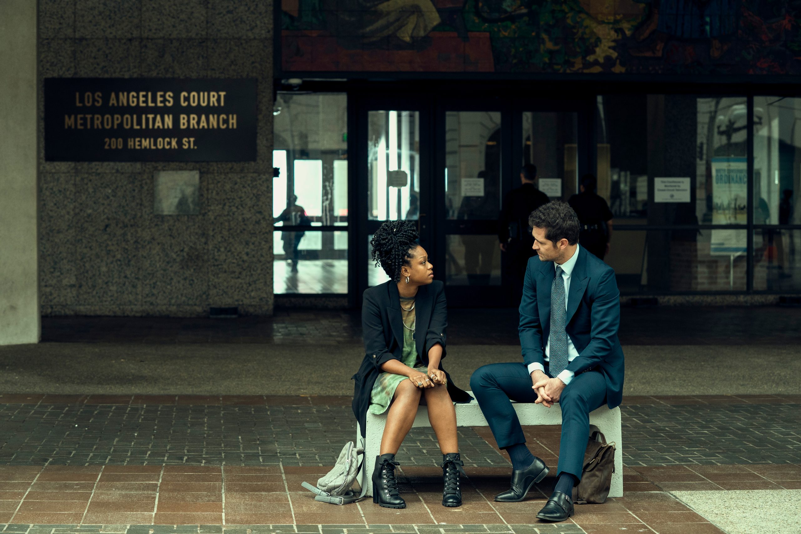 The Lincoln Lawyer. (L to R) Jazz Raycole as Izzy, Manuel Garcia-Rulfo as Mickey Haller in episode 101 of The Lincoln Lawyer. Cr. Lara Solanki/Netflix © 2022