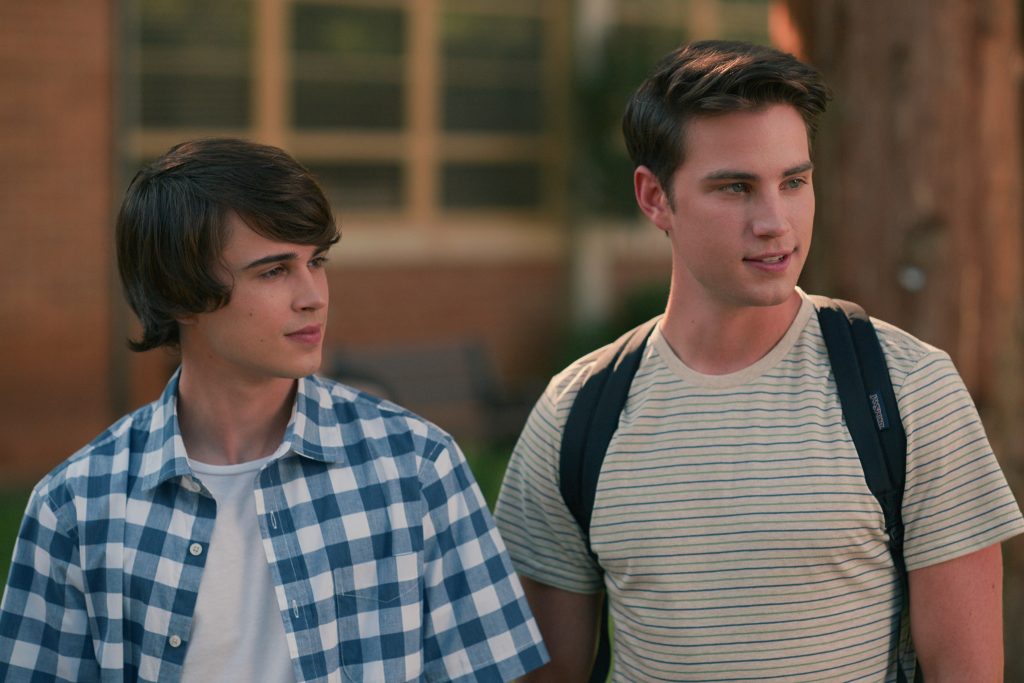 Sweet Magnolias characters Kyle and Ty at standing outside of Serenity High School. Cr. Courtesy of Netflix © 2023