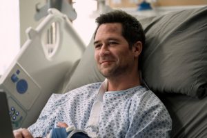 The Lincoln Lawyer character Mickey Haller - man wearing gown in bed at the hospital