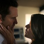 The Lincoln Lawyer character Maggie faces character Mickey Haller and holds her hand on his right cheek.