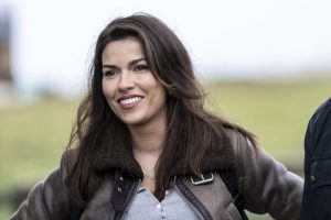 Actor Sofia Pernas wearing blue shirt and brown leather jacket on Tracker series on CBS.